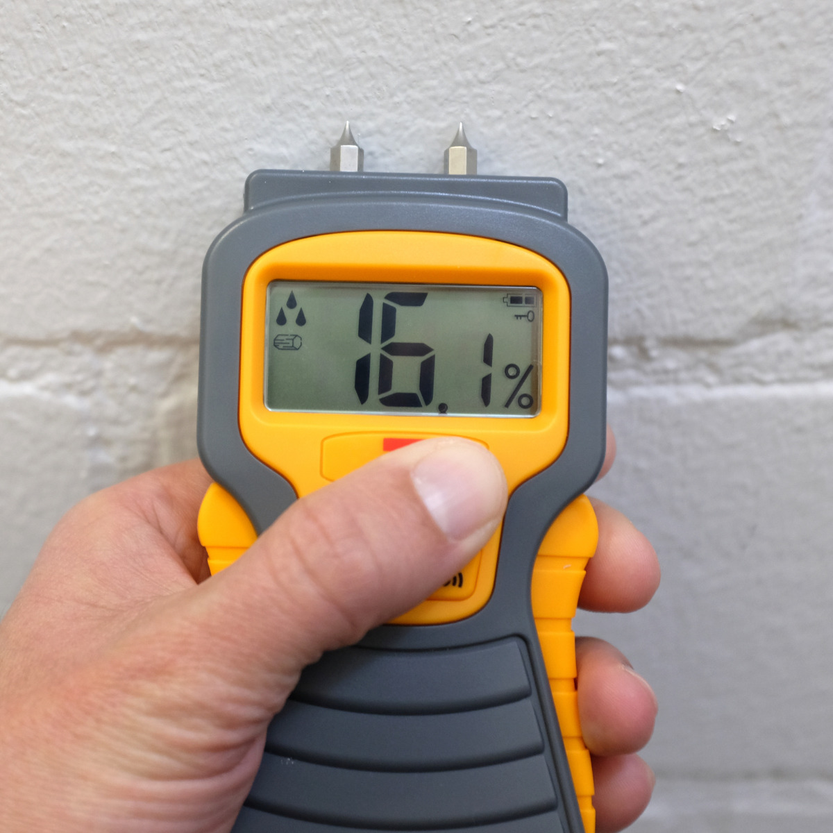 Moisture meter checking a wall after water exposure